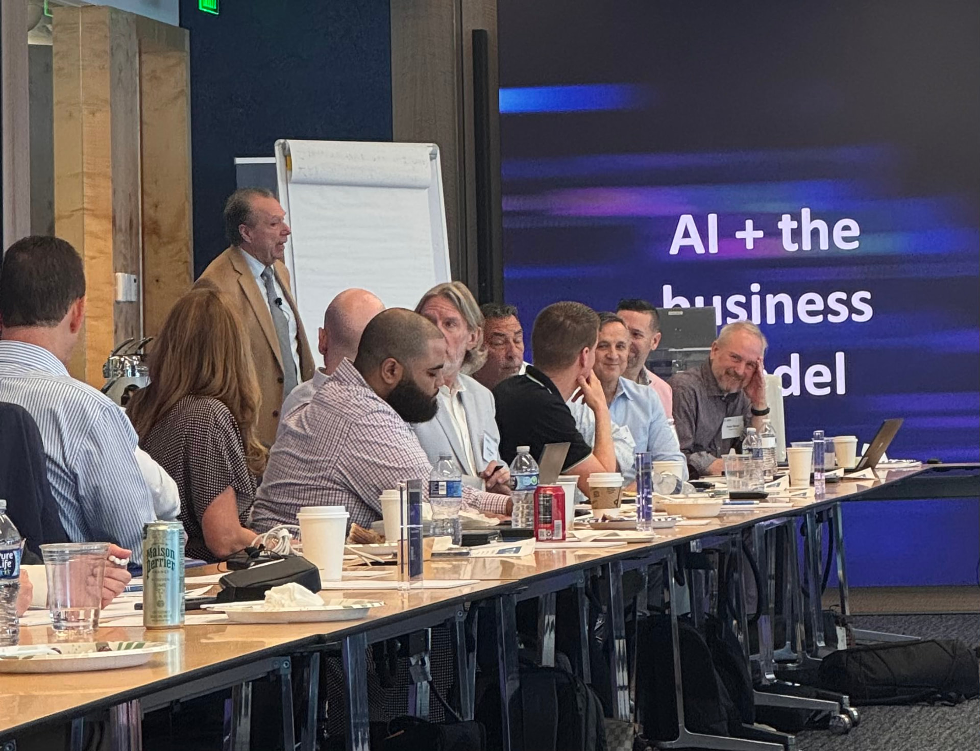 Leaders laughing during the AI and the business model session